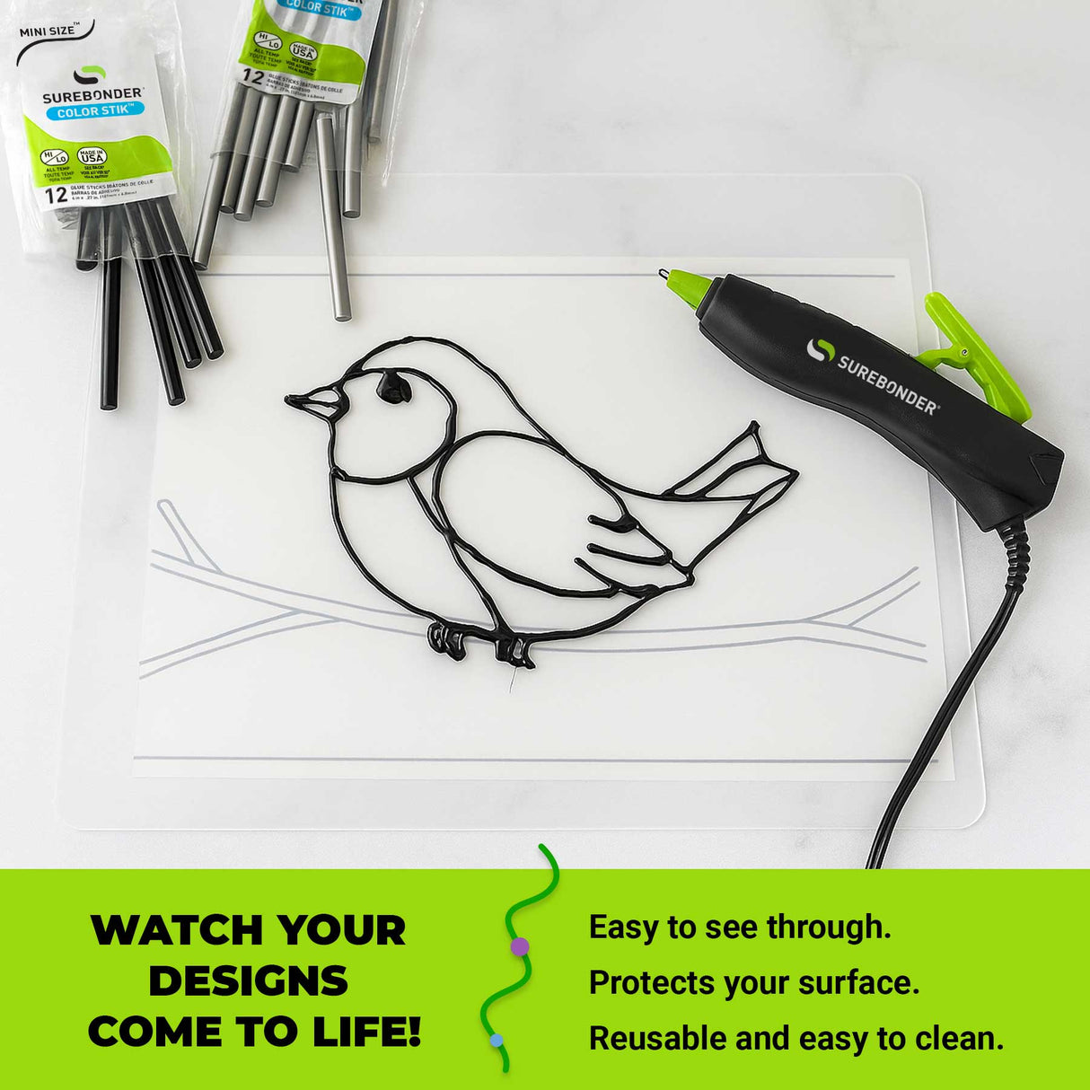 Surebonder hot glue pen with a bird design on a our transparent surface mat, surrounded by glue sticks and packaging.