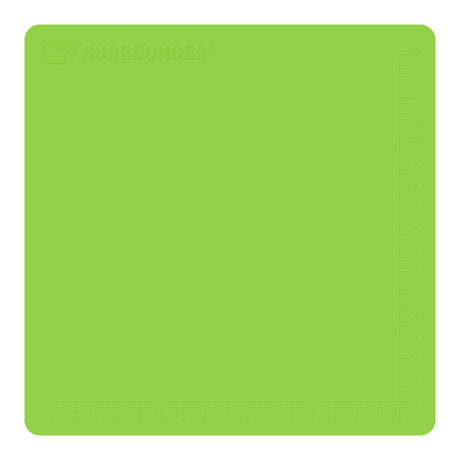 Hot glue gun hovers over a large green Surebonder silicone pad, measures 19 inches by 19 inches