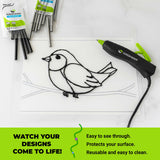 Surebonder hot glue pen with a bird design on a our transparent surface mat, surrounded by glue sticks and packaging.