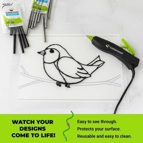 Surebonder hot glue pen with a bird design on a our transparent surface mat, surrounded by glue sticks and packaging.