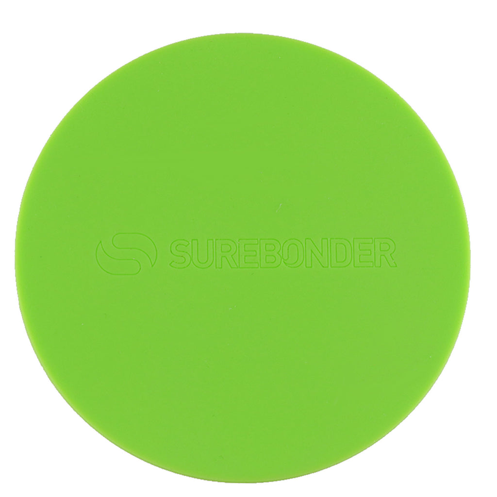 Hot glue gun hovers over a round green Surebonder silicone pad, measures 4 inches diameter