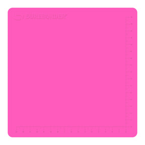 Hot glue gun hovers over a large pink Surebonder silicone pad, measures 19 inches by 19 inches